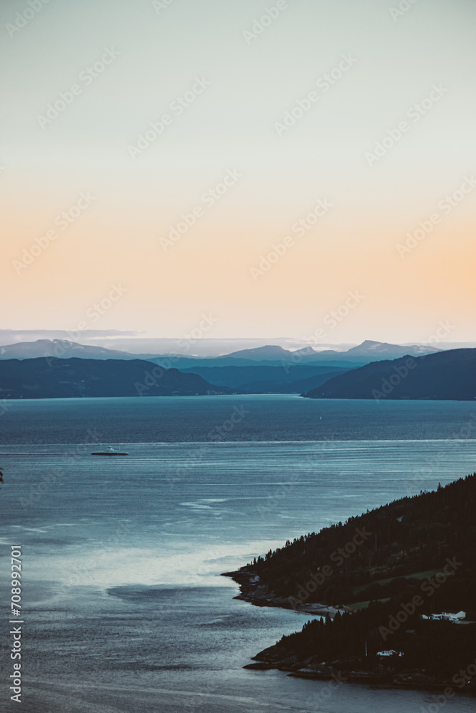 Orange sky in the mountains. Boat on sea