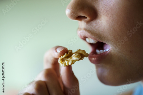 Unrecognizable girl about to eat delicious walnut at home © javiindy