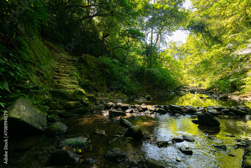 Summer stream with rocks and mountain trail in new taipei city.