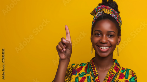 African american girl warning raised forefinger up, does admonishing gesture, giving advice to avoid danger photo