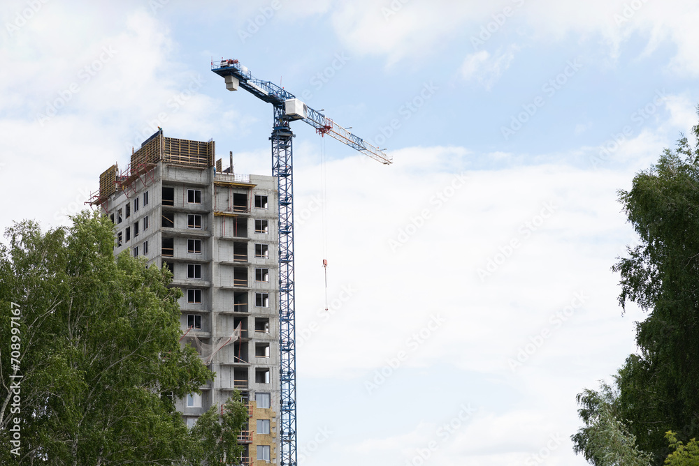 Fototapeta premium A construction crane on a blue sky background.