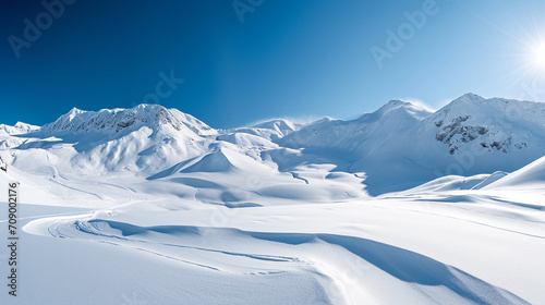 Wallpaper Mural Stunning panoramic view of snowy mountain range. The untouched powder snow with ski tracks crisscrossing. Bright and crisp winter day with snow capped peaks and clear blue sky. Cold adventure and expe Torontodigital.ca
