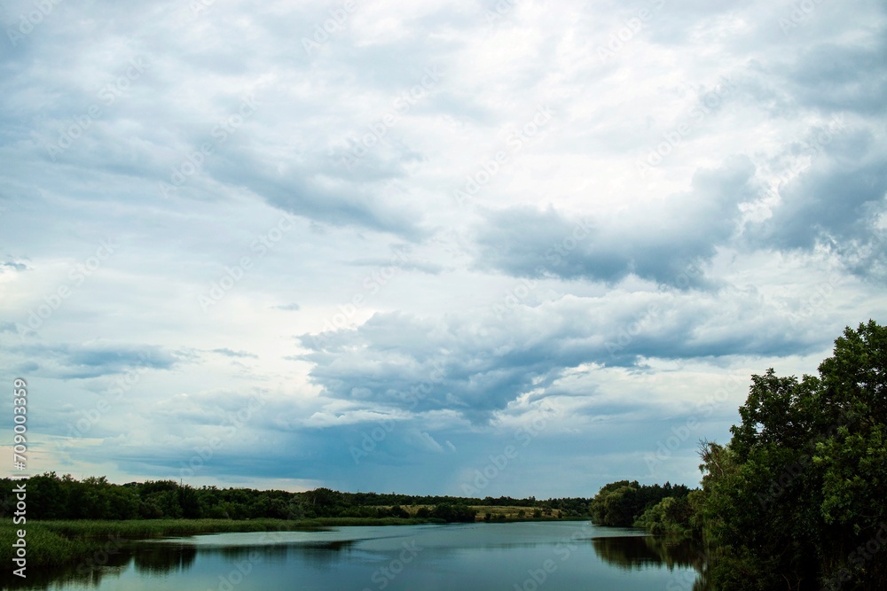 Cloudy sky over the river, summer landscape, river bank, nature series, Ukraine 