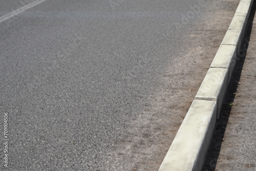 Wallpaper Mural city sidewalk. low stone curb on a city street, gray sidewalk. city life concept Torontodigital.ca