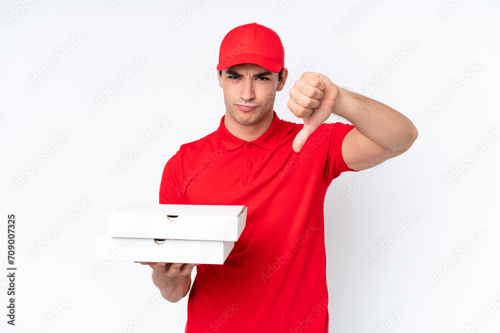 Pizza delivery caucasian man with work uniform picking up pizza boxes isolated on white background showing thumb down with negative expression Pizza delivery caucasian man with work uniform picking up pizza boxes isolated on white background showing thumb down with negative expression