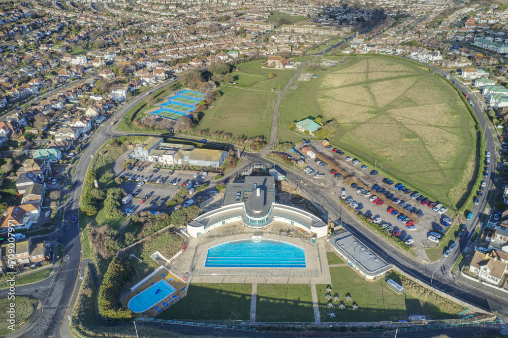 Aerial photo of the Saltdean art deco designed Lido behind the White Chalk Cliffs and on the seafront of Saltdean in East Sussex England.