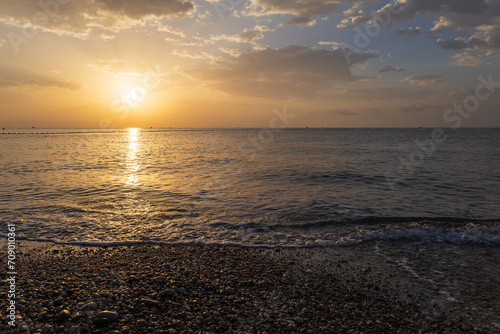 Landscape by the sea in Greece on the island of Rhodes. Sunrise, dramatic clouds. Beautiful background.