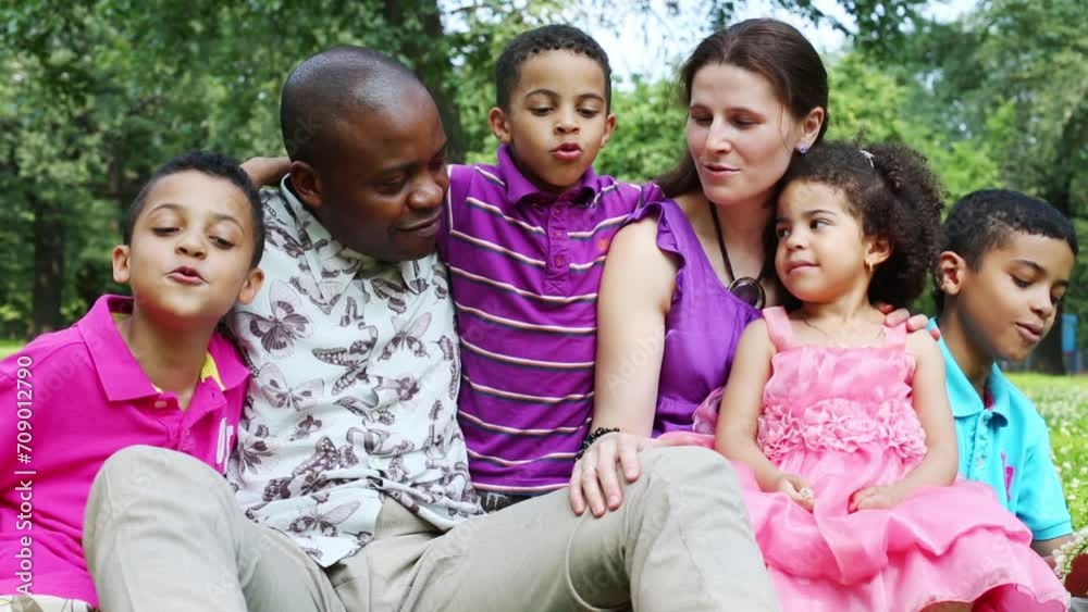 Happy family of six sings and hugging in a summer park Happy family of six sings and hugging in a summer park