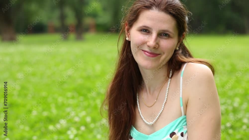 Beautiful young woman with long hair resting in park Beautiful young woman with long hair resting in park