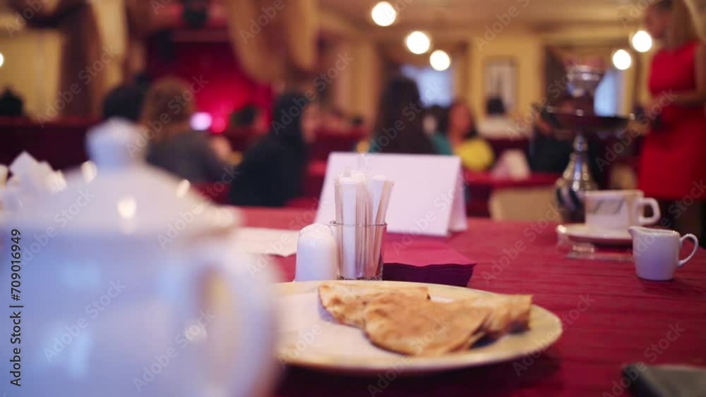Small cakes on white plate on table in restaurant Small cakes on white plate on table in restaurant