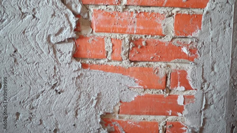 New brick wall with plaster in apartment without finishing