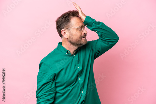 Middle age caucasian man isolated on pink background has realized something and intending the solution