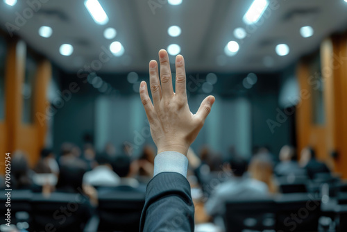 Photo of people asking questions or making presentations, journalists raising their hands in the audience © lc design