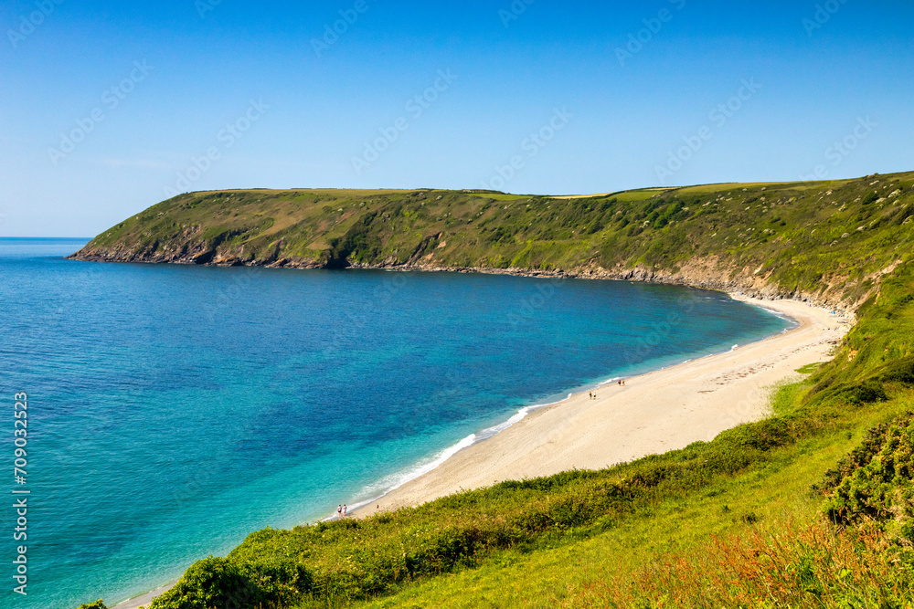 Vault Beach, Roseland Peninsula, Cornwall, UK. Clear blue sky and an almost deserted beach.