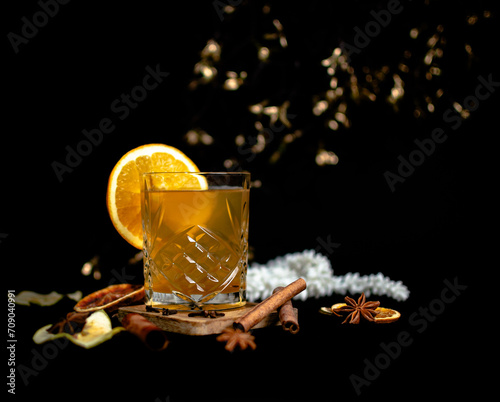 Winter cocktail with honey and orange on a black background © Joanna