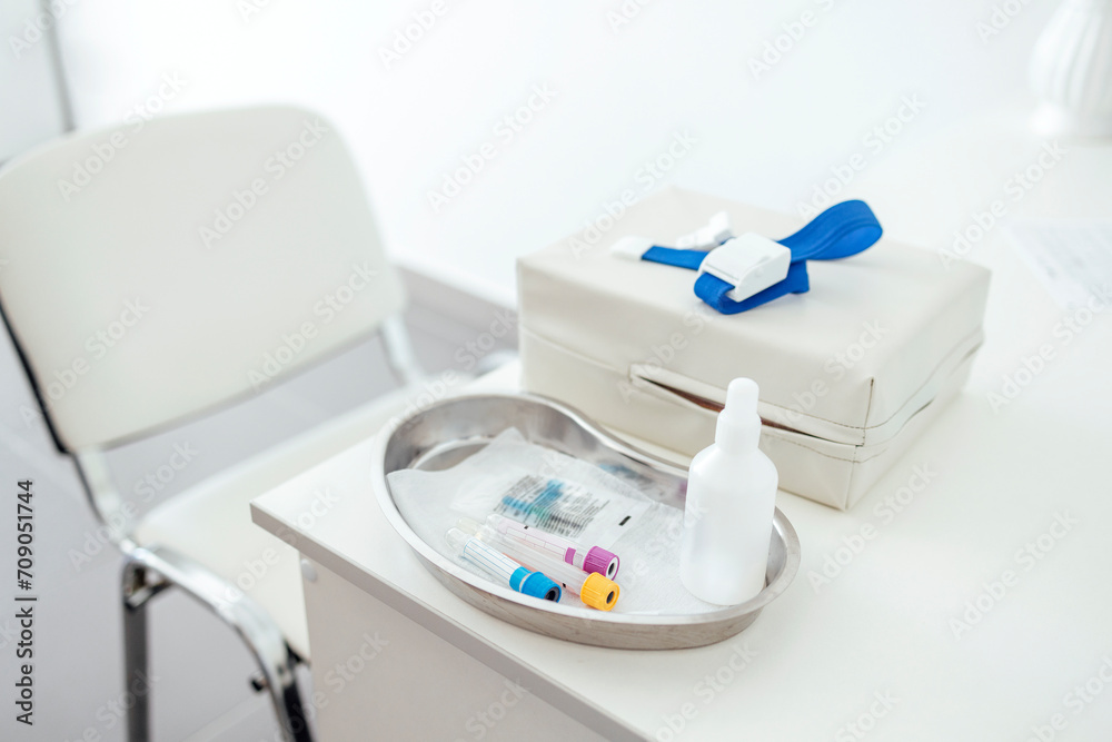 The desktop of a medical worker or nurse. Blood collection devices on a white table.