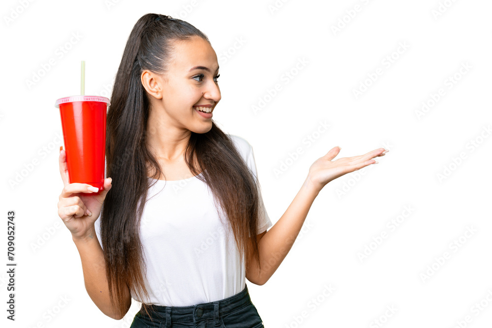 Young Arabian woman holding soda over isolated chroma key background with surprise facial expression Young Arabian woman holding soda over isolated chroma key background with surprise facial expression