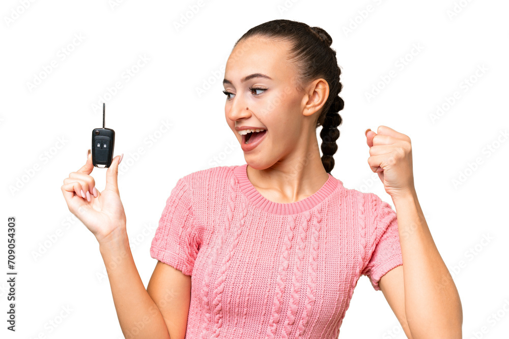 Young Arab woman holding car keys over isolated background celebrating a victory Young Arab woman holding car keys over isolated background celebrating a victory