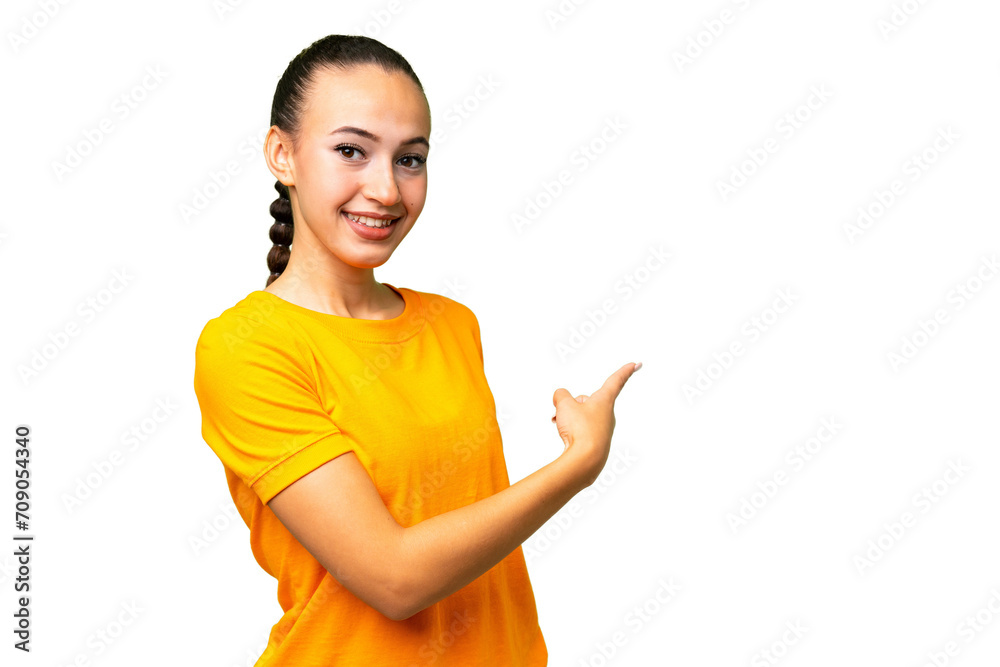 Young Arab woman over isolated background pointing back Young Arab woman over isolated background pointing back
