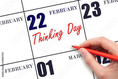 February 22. Hand writing text Thinking Day on calendar date. Save the date.