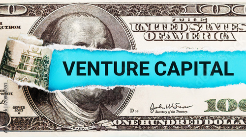 Venture Capital. The word Venture Capital in the background of the US dollar. Investment in Innovation, New Business, and Growth Concept photo
