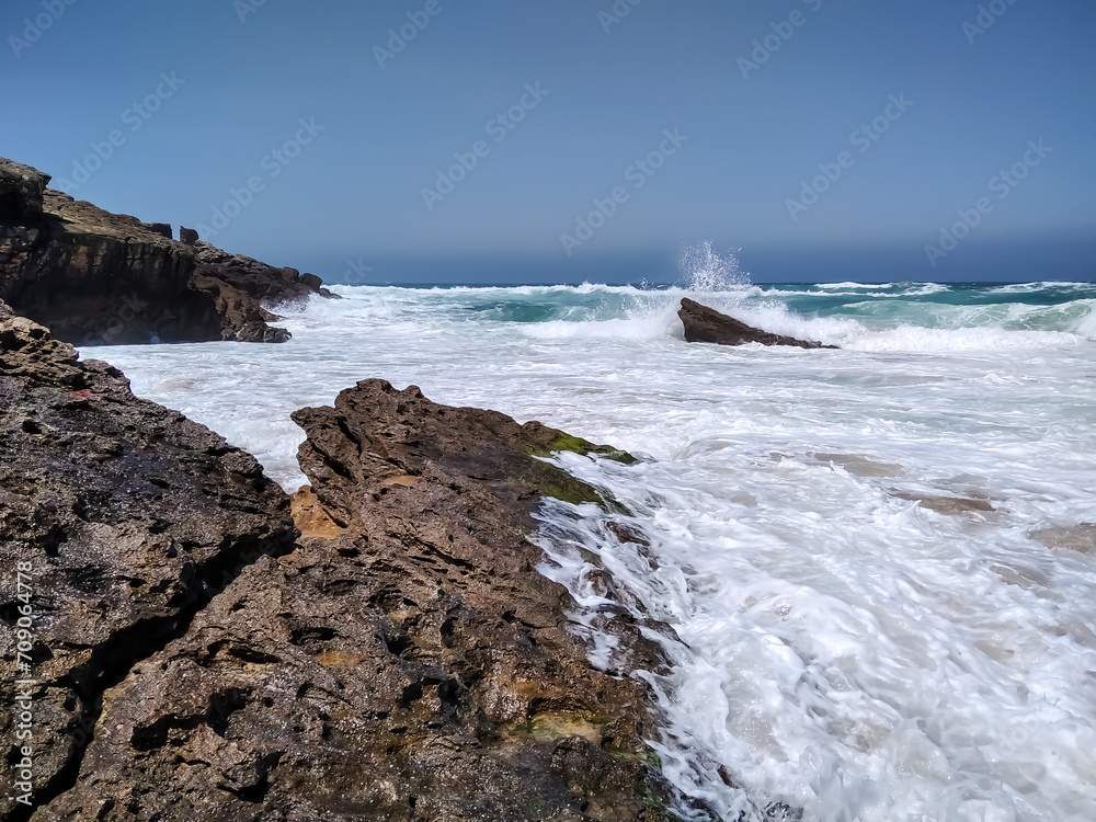 On the shore of the Atlantic Ocean. Stones. Ship. Portugal. Cascais.