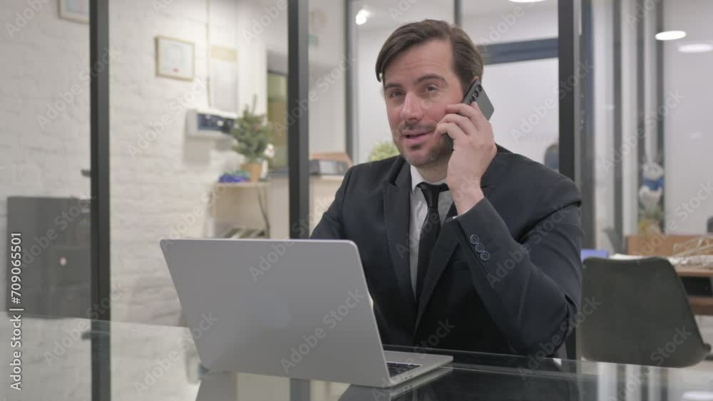 Middle Aged Businessman Talking on Phone Middle Aged Businessman Talking on Phone