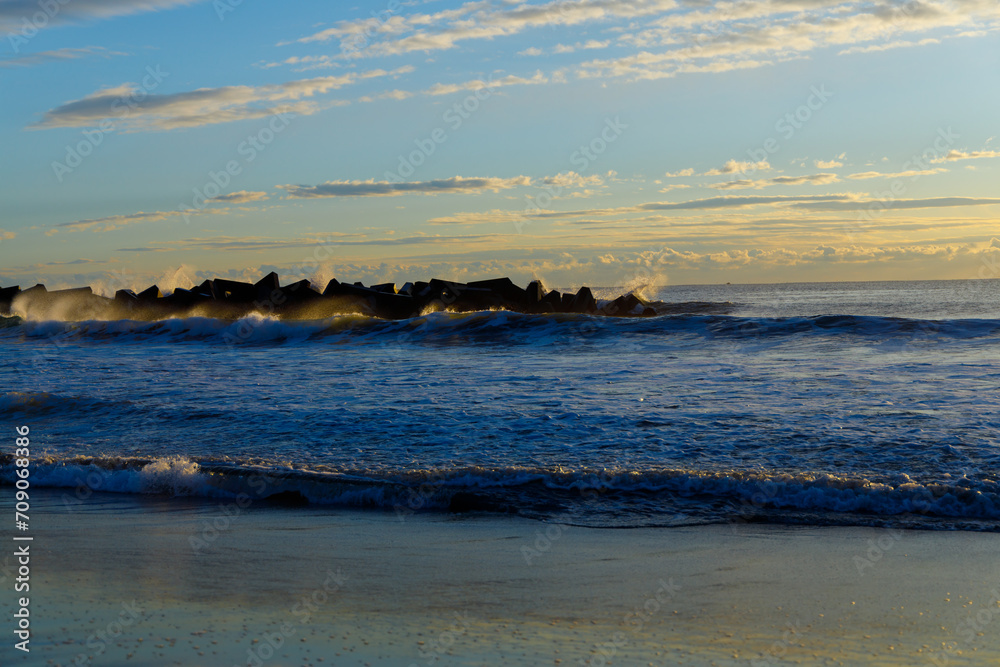 Sunrise on the beach with blue sky and orange clouds Sunrise on the beach with blue sky and orange clouds