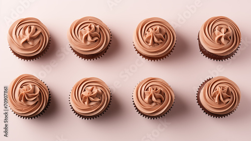 Cupcakes with chocolate buttercream frosting on a beige background