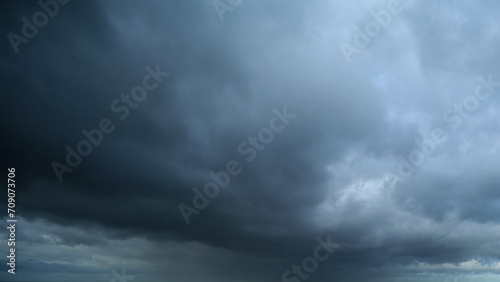Black stormy sky covered with dark rain clouds photo