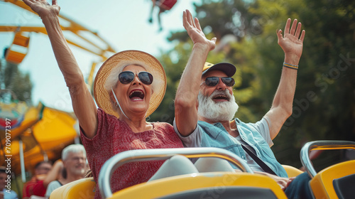 Elderly senior couple traveling at an amusement park, roller coaster Vikings joyful, Elderly society, father and mother travel photo