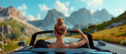 Happy blond hair woman enjoying summer on long road trip, luxury cabrio adventure, wealth and freedom lifestyle photo