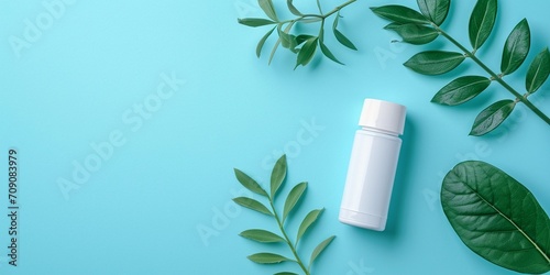 On a blue background, a flat lay composition with deodorant. Concept of beauty, hygiene, and cosmetics. Top view, copy space, and long banner format