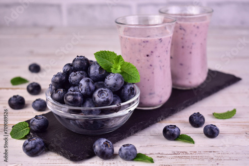 Blueberries and blueberry smoothie on a white background. 
