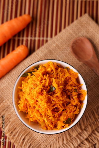 Kerala cuisine Carrot stir fry with coconut thoran poriyal  served in bowl.  carrot based curry for Onam sadya from India.   photo