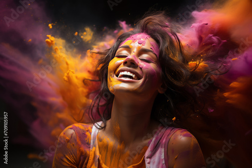 Woman with colored powder on her face expresses joy, embodying a festival of color. © Duka Mer