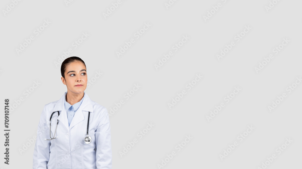 Confident young european doctor in a white lab coat with a stethoscope Confident young european doctor in a white lab coat with a stethoscope