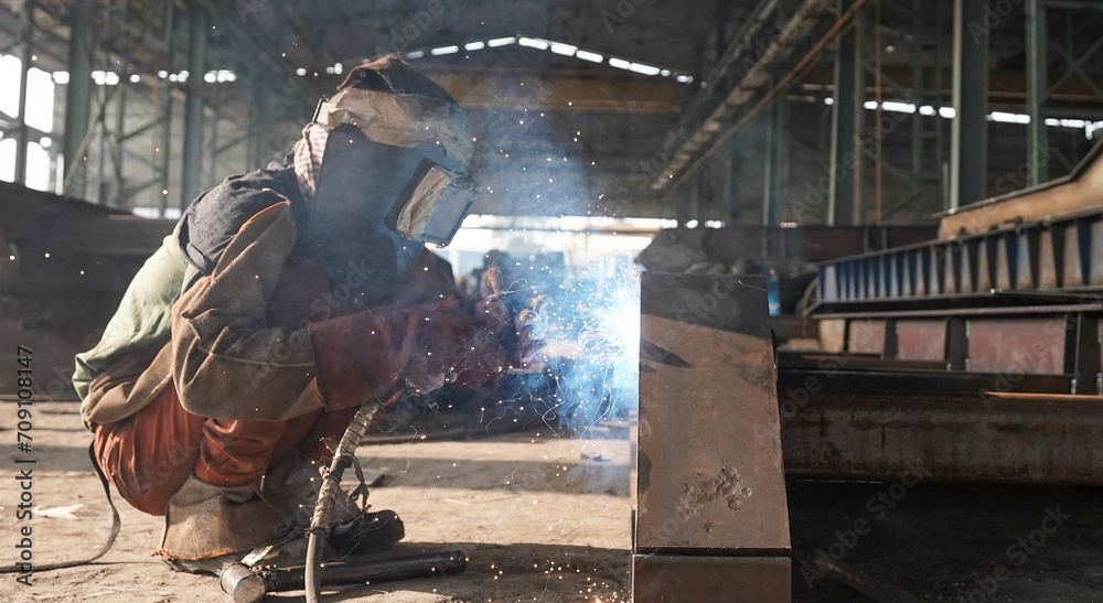 welder working on the factory, Welder erecting technical steel, Industrial steel welder in factory technical, Close-up and wide of a welder wielding sparks stock photo