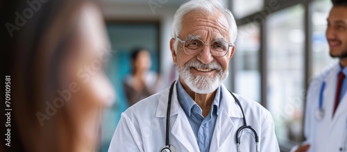 Elderly physician enjoying teaching medical students