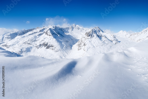 Winter mountain landscape. Wallpaper or background. Cold weather and frost. A place for skiing. Ski resort. High rocks and snow. View of mountains. © biletskiyevgeniy.com