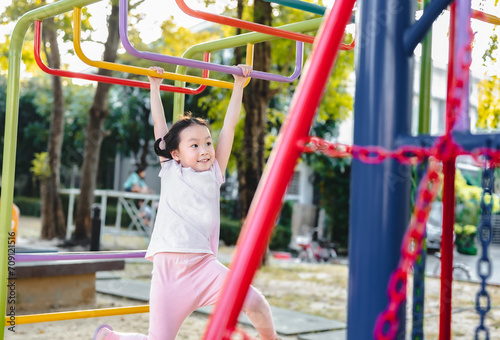 Happy child girl  playing at outdoor playground in the park on , outdoor or playground