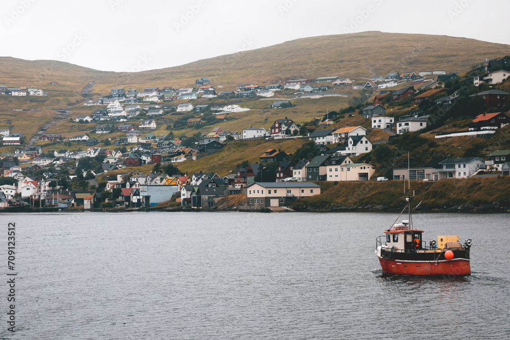 Fototapeta premium boats on the fjord near a nordic village