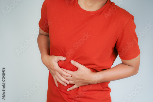 Wallpaper Mural male having stomach ache, bending over and holding hands on stomach, uncomfortable due to stomach cramps, gastric pain Torontodigital.ca