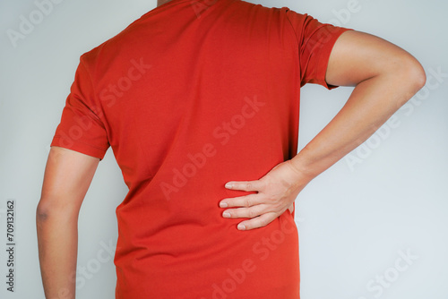 A man has chronic lower back pain and suffers from lower back pain