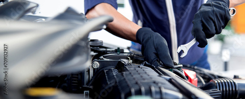 Professional mechanic working on the engine , repairing a car engine automotive workshop with a wrench, car service and maintenance,Repair service.