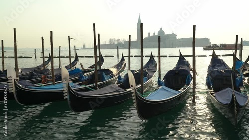 Gondolas docked at San Marco Canal with San Giorgio Maggiore island in the background in Venice, Italy
 photo
