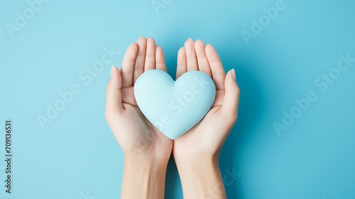 Hands Forming a Heart Shape, Symbolizing Love and Support in Healthcare. Cropped Top Photo Over Blue Background, Conceptualizing the Essence of Saving Lives and Providing Medical Assistance