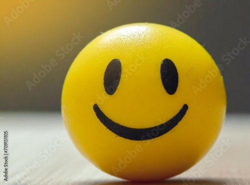 Yellow smiling face ball closeup photography. Happiness concept.