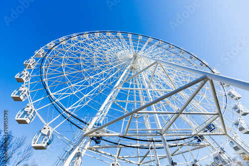 Ferris wheel against blue sky .