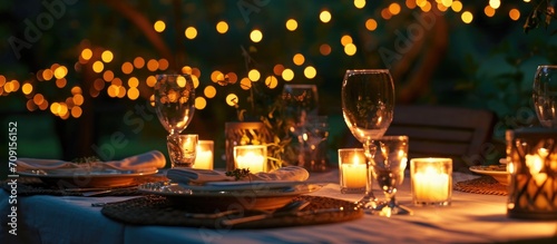 Outdoor dinner with candlelit glasses. photo